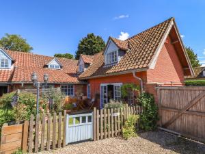 a house with a wooden fence in front of it at Gables Cottage in Market Rasen +55 photos