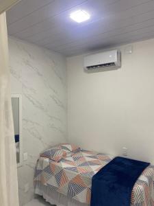 a bedroom with a bed and a air conditioner at APTO - Espaço Vix II in Vitória
