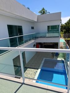 two views of a house with a swimming pool at Pousada Natural Hostel in Maragogi