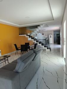 a living room with a couch and a dining room at Pousada Natural Hostel in Maragogi