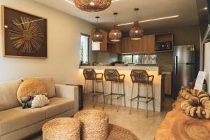a living room with a couch and a kitchen at Casa Mandala - Rooftop com Jacuzzi e Vista Mar in Barra Grande +104 photos