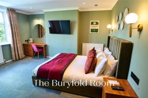 a hotel room with a bed and a desk at Springbank Manor in Darwen