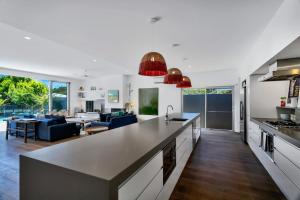 an open kitchen and living room with a dining room at Stonecutters 2 in Byron Bay
