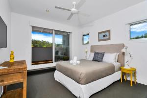 a bedroom with a bed and a window at Stonecutters 2 in Byron Bay +70 photos
