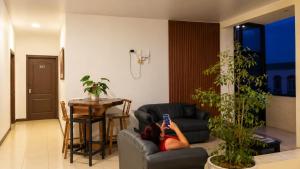 a woman laying on a couch in a living room at BCHotel in Siguatepeque