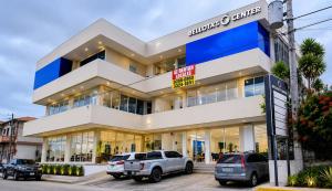a building with cars parked in front of it at BCHotel in Siguatepeque