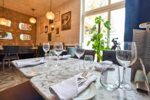 a table in a restaurant with wine glasses on it at Springbank Manor in Darwen