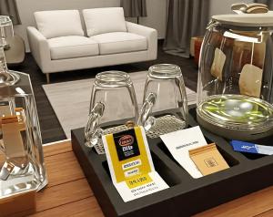 a table with a tray with glass jars and a box at Samal Hillside Inn in Samal