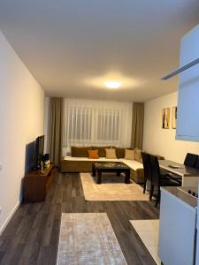 a living room with a couch and a table at City-Center Space in Mitrovica