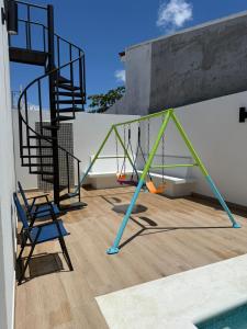 a swing set on the side of a building at Casa Brisas del Sur in San Juan del Sur