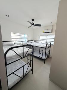 two bunk beds in a room with a ceiling fan at Casa Brisas del Sur in San Juan del Sur +2 photos