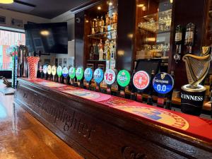 a bar with a row of bottles of alcohol at Coopers Lane in Dublin