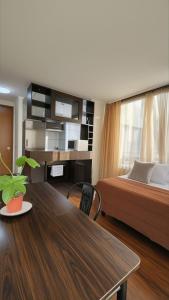 a bedroom with a bed and a table with a desk at Apartments Bellas Artes in Santiago