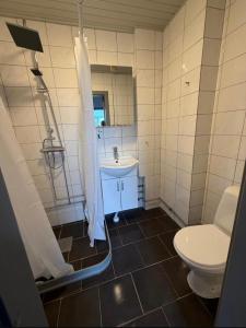 a bathroom with a toilet and a sink at Four bedroom house close to the beach in Abbekås