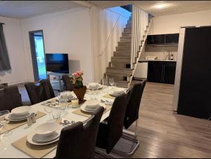 a dining room with a table and chairs and a staircase at Four bedroom house close to the beach in Abbekås