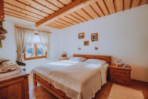 a bedroom with a large bed and a window at Babičkina Chalúpka in Pohorelá
