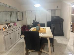 a dining room with a table and chairs in a kitchen at Up Center in Comodoro Rivadavia +1 photo