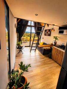 a view of a living room with a ladder in a room at Basecamp Colombia in Carmen de Carupa