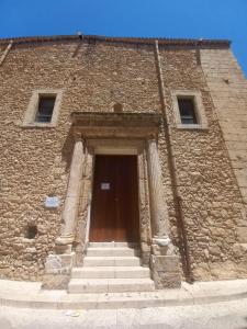 a stone building with stairs leading to a door at Room via Florio in Alcamo +2 photos