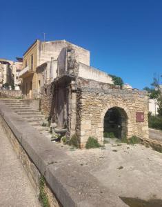 an old stone building on the side of a street at Room via Florio in Alcamo