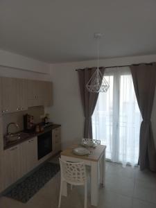 a kitchen with a table and a table and a chair at Room via Florio in Alcamo