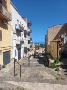 an alley in a city with buildings at Room via Florio in Alcamo