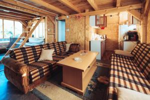 a living room with a couch and a table at Vikendica Na Plivi E&M in Šipovo