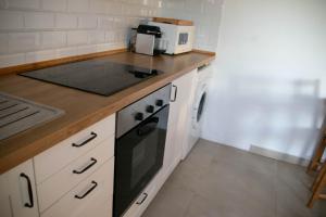 a kitchen with a stove top oven next to a sink at Casa El Palmar - Playa y Jardín in El Palmar