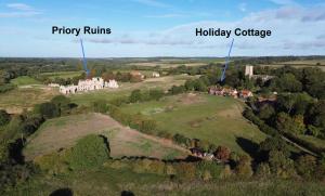 an aerial view of a house on a hill at Priory Cottage Castle Acre in Castle Acre