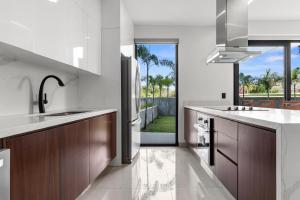 a kitchen with wooden cabinets and a large window at Anthus Flamingos Condominio 301 in Bucerías