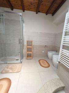 a bathroom with a shower and a toilet and a sink at la casa del viaggiatore in Bronte