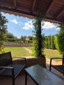 a patio with two tables and a view of a yard at Villas garden&pool in Afitos