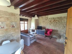 a living room with a desk and a red chair at Villas garden&pool in Afitos
