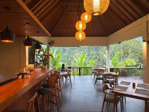 a restaurant with a bar and tables and chairs at The Sidemen Villa in Sidemen