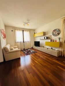 ein Wohnzimmer mit Sofa und Fernseher in der Unterkunft CESENAinCENTRO in Cesena