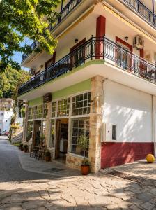 a building with a balcony on top of it at Amaya Pine Studio in Panagia