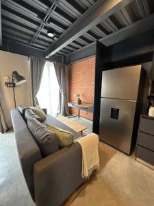 a living room with a couch and a refrigerator at Tradere in Guadalajara