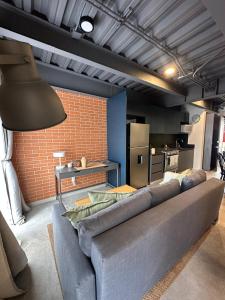 a living room with a couch and a brick wall at Tradere in Guadalajara +41 photos