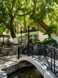 a bridge over a river in front of a building at Amaya Pine Studio in Panagia +56 photos