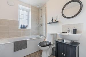 a bathroom with a sink toilet and a mirror at The Mersey Sanctuary in Liverpool