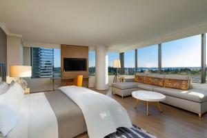 a hotel room with a large bed and a couch at The Westin Bellevue in Bellevue