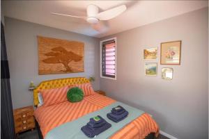 a bedroom with a bed with two towels on it at The Royale Bundeena in Bundeena