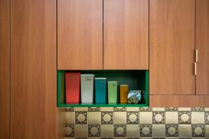 a row of books on a shelf in a kitchen at The Royale Bundeena in Bundeena