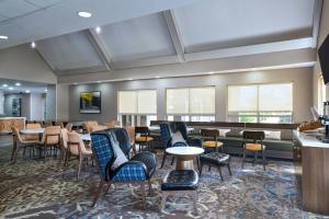 a restaurant with chairs and tables and a bar at Residence Inn Corpus Christi in Corpus Christi