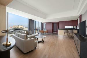 a living room with a couch and a table at Renaissance Beijing Capital Hotel in Beijing