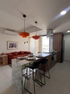 a kitchen with a large island in a living room at Visa Trip Cozy Stay in Guadalajara