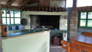 a kitchen with a stone fireplace in a room at Guesthouse Porec in Poreč