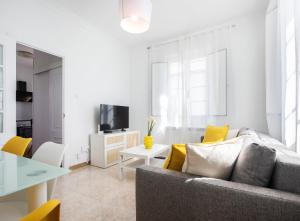 a living room with a couch and a table at Casa Raxón Ferrol in Ferrol