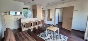 a kitchen with a table and chairs in a room at T8 Sunset Tihany 19 in Tihany