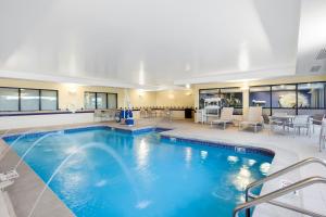 a large swimming pool with blue water in a building at SpringHill Suites by Marriott Omaha East, Council Bluffs, IA in Council Bluffs